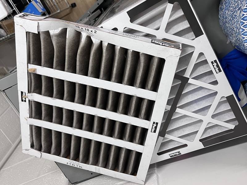 Dirty pleated filter next to the new one