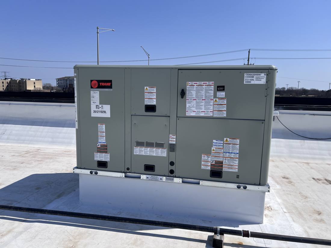 New Trane rooftop unit RTU-11 set on the adapted curb