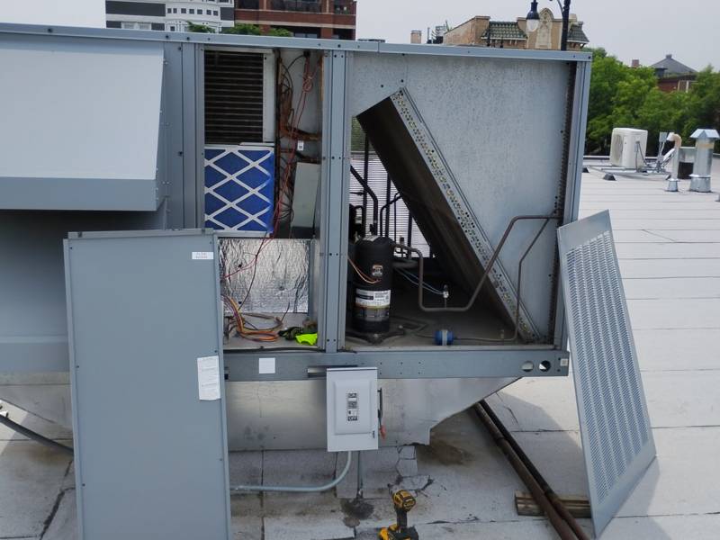 Rooftop unit open for a maintenance visit